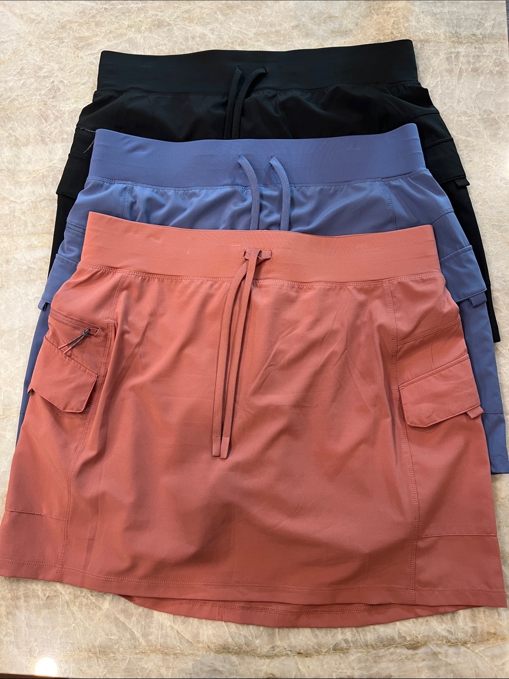 Three GerryPerformance Cargo Skirt - Rose Blue, Black